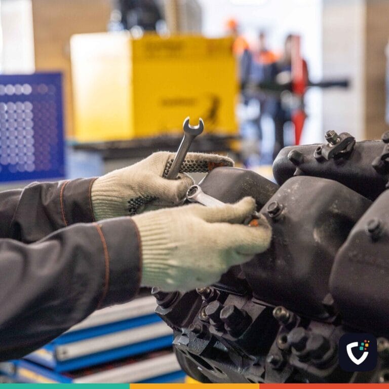 Close-up of a mechanic's hands working on an engine in a modern workshop