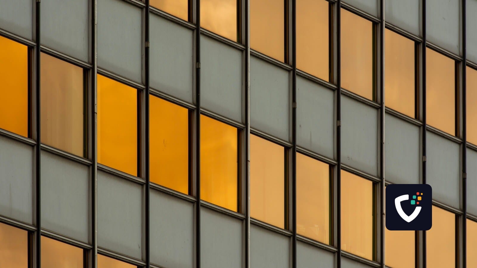 Abstract pattern featuring urban office building windows reflecting the sunset