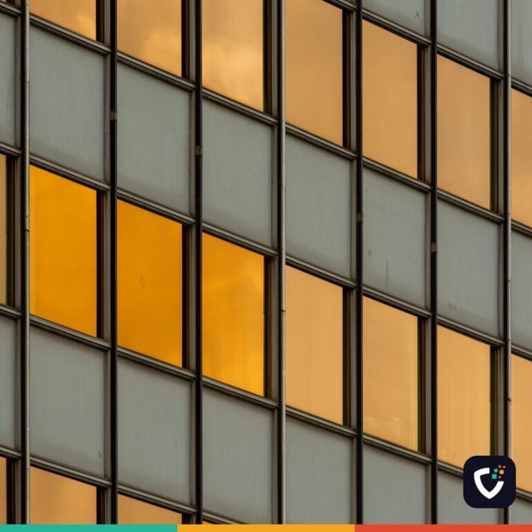 Abstract pattern featuring urban office building windows reflecting the sunset
