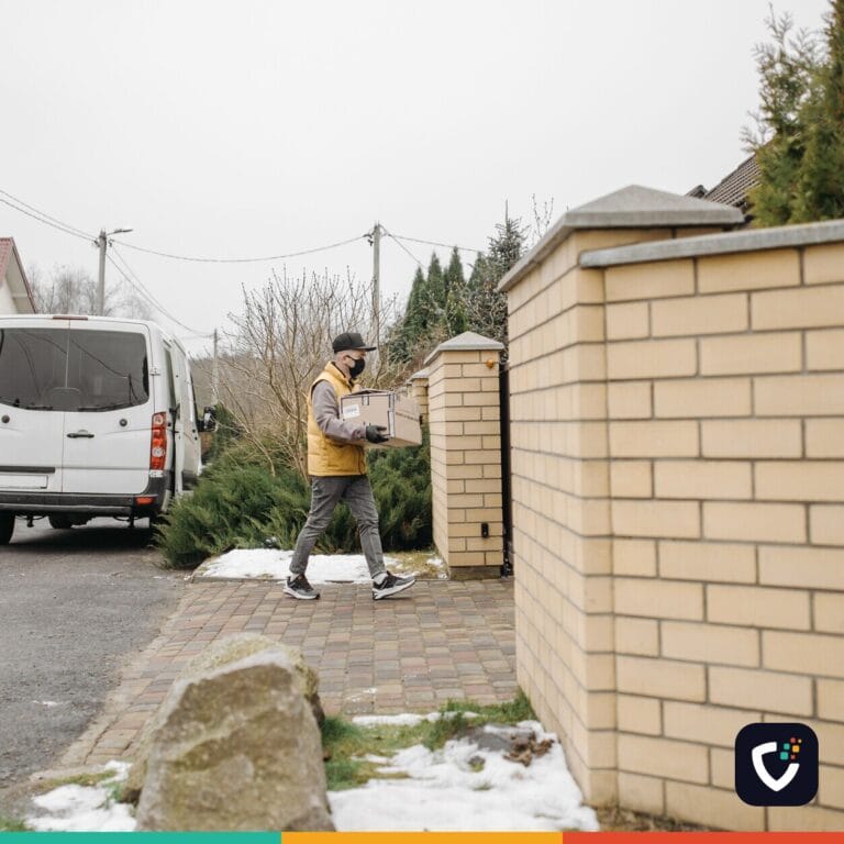 Courier delivers a package in suburban neighborhood with white delivery van nearby
