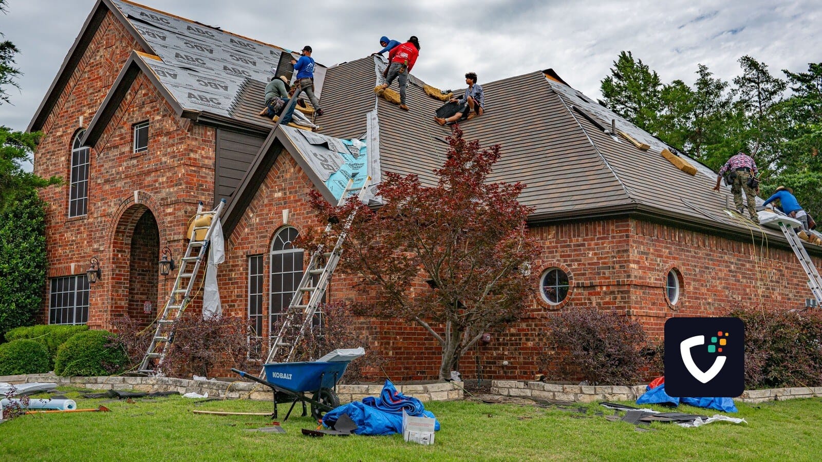 Roofers working on brick home in Allen, Texas, addressing shingles and roofing materials