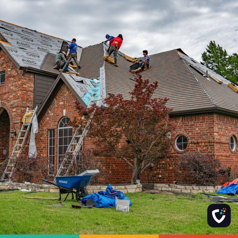 Roofers working on brick home in Allen, Texas, addressing shingles and roofing materials