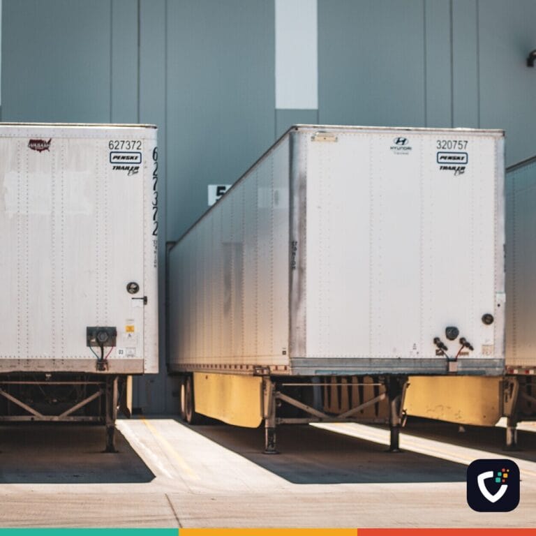 A row of freight trailers parked at a commercial loading dock, emphasizing transportation and logistics