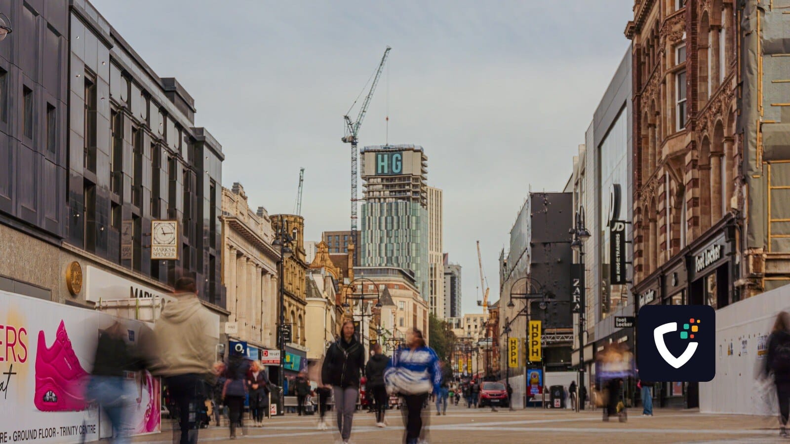Bustling pedestrian street in downtown Leeds, UK, capturing the urban architecture and city life