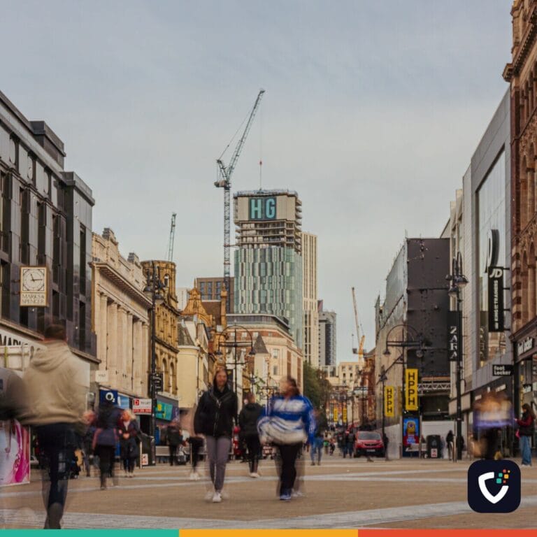 Bustling pedestrian street in downtown Leeds, UK, capturing the urban architecture and city life