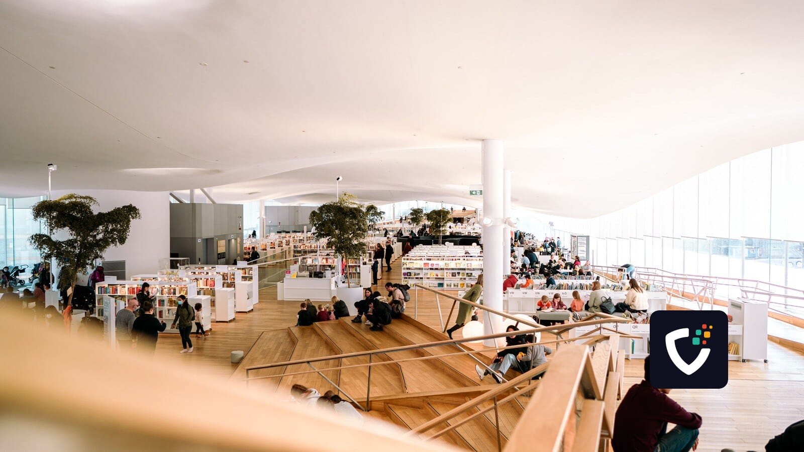Contemporary library interior filled with people reading and relaxing in a bright and open space