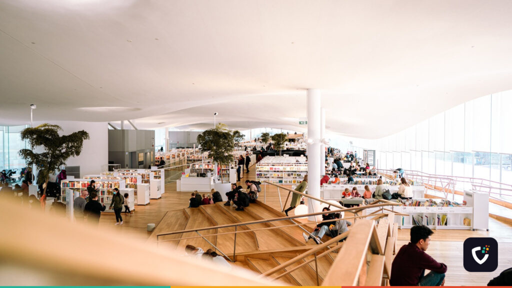 Contemporary library interior filled with people reading and relaxing in a bright and open space