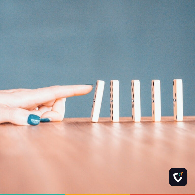 A finger about to topple a row of dominoes