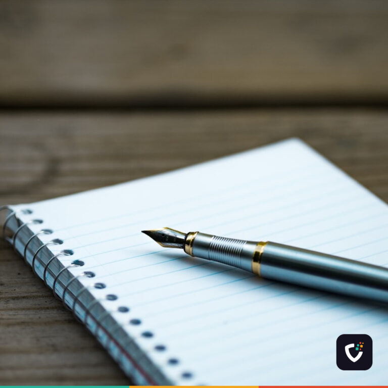 A fountain pen resting on a notebook